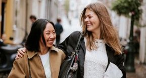 Twee vriendinnen lopen vrolijk door de stad